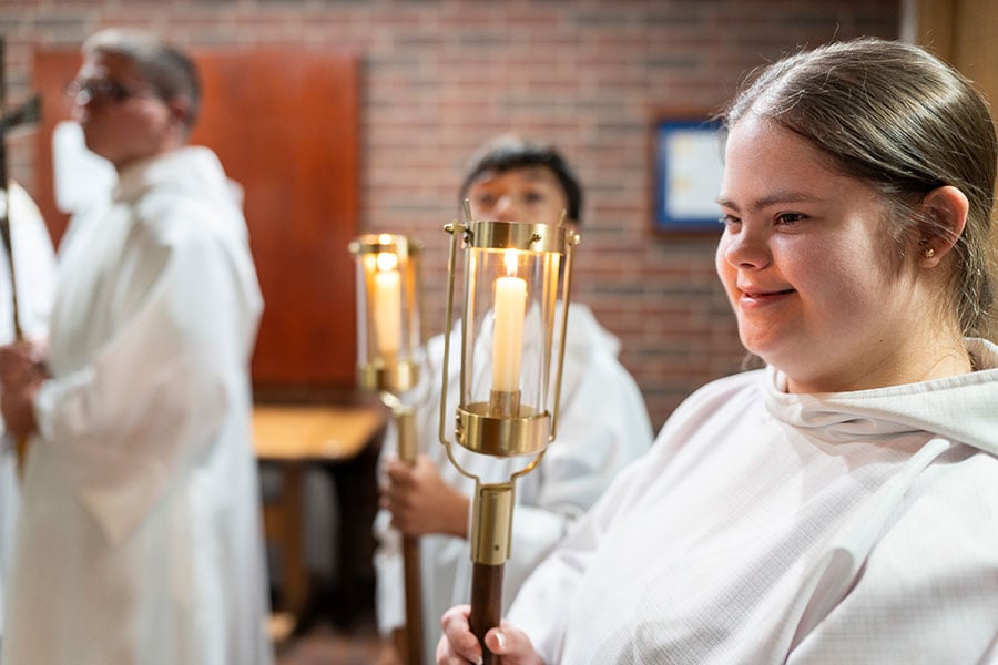 Altar servers with down syndrome bear candles